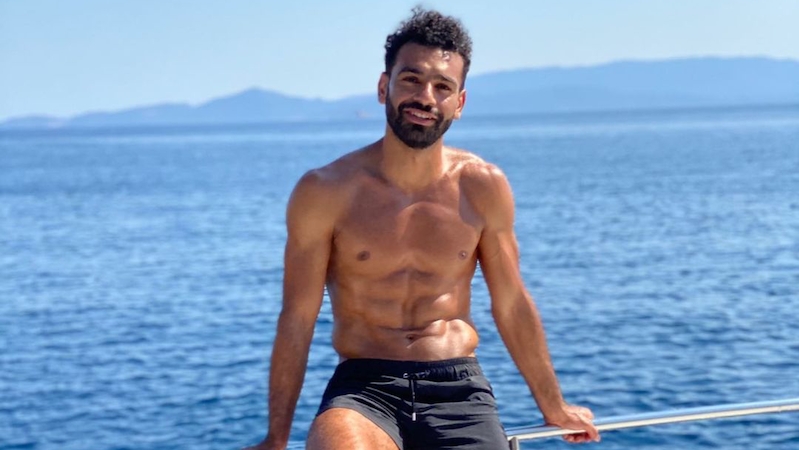 Mohamed Salah poses for photos on a boat
