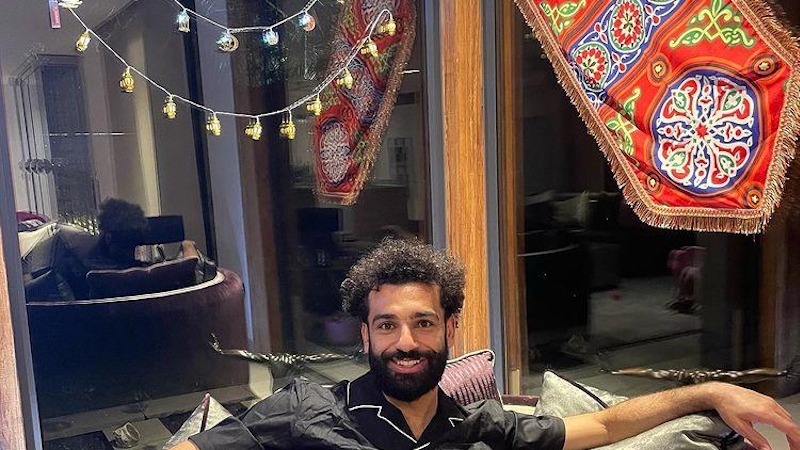 Salah poses for a photo in his Manchester home