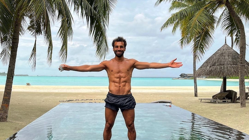 Mohamed Salah poses for a photo at a beach resort
