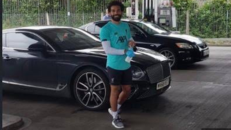 Mohamed Salah poses with his garage of cars