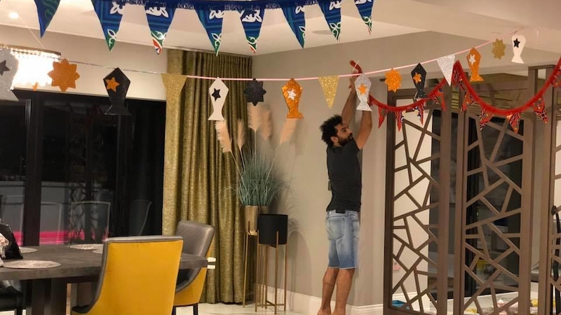 Mohamed Salah hanging decorations in his house
